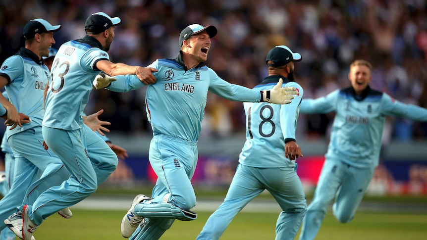 England players dash across the field in celebration after winning the Cricket World Cup final