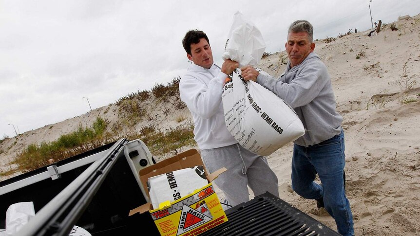 Residents fill sand bags as Hurricane Sandy approaches in Long Beach, New York.