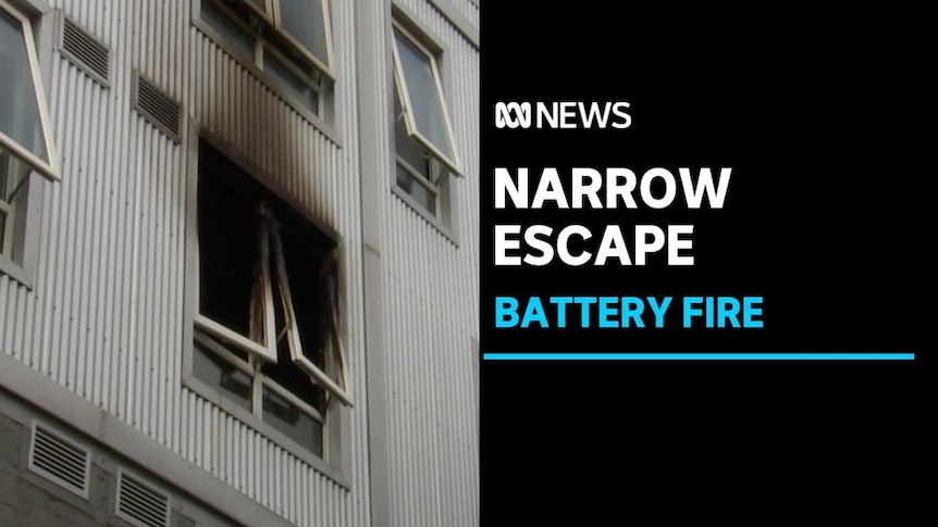 Narrow Escape, Battery Fire: Exterior of a building with a burnt out window.