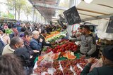 French people look around Barbes Market ahead of the presidential election