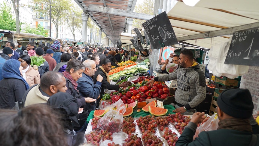 French people look around Barbes Market ahead of the presidential election