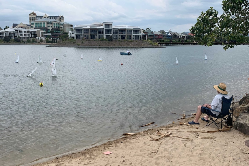 Paradise Radio Yacht Club member watches from shore as race is underway at Emerald Lakes.