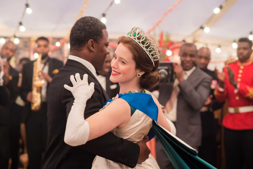 Queen Elizabeth (Claire Foy) and Kwame Nkrumah (Danny Sapani) dance in The Crown.