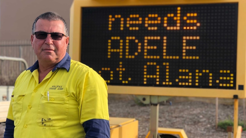 Bunbury businessman Nick De Marte standing in front of an electronic sign which says 'needs Adele not Alana'