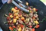 A wok full of a colourful stir fry.
