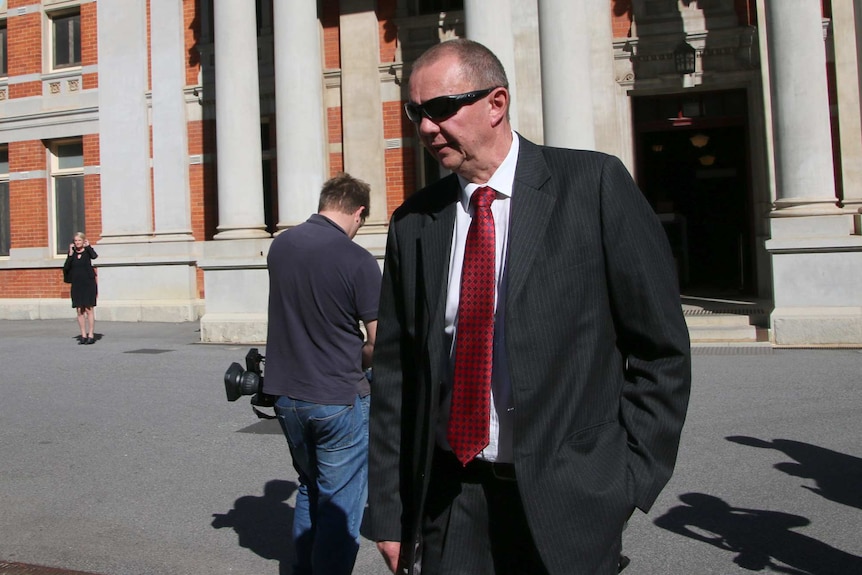 Retired detective John Hendriksen leaves court.