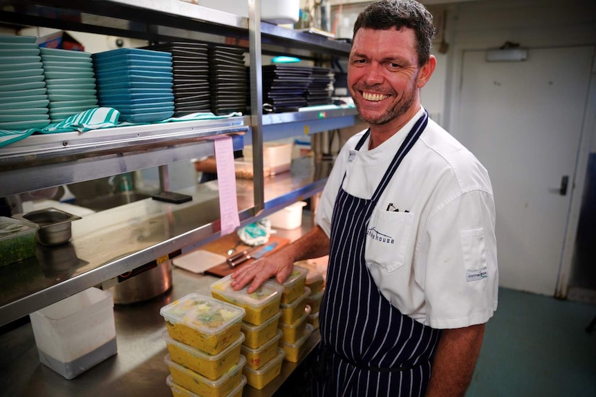Shorehouse head chef in the kitchen with take-away meals.