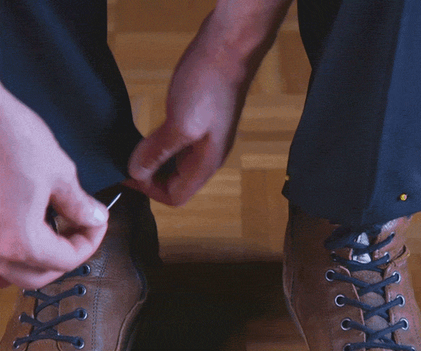 Gif of folded pants being pinned at the desired length.