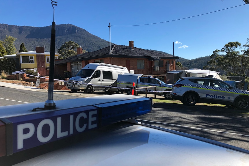 Police cars outside a house on Huon Road