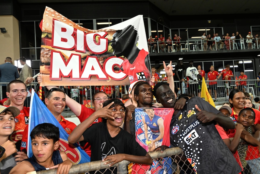 Mac Andrew of the Suns is seen with fans after the AFL Round 10 match 