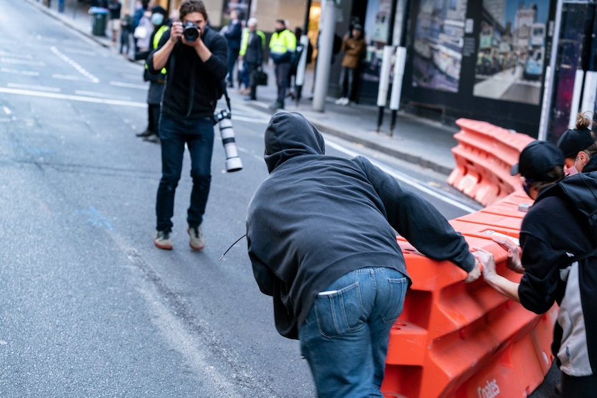 protesters moving a street blockade