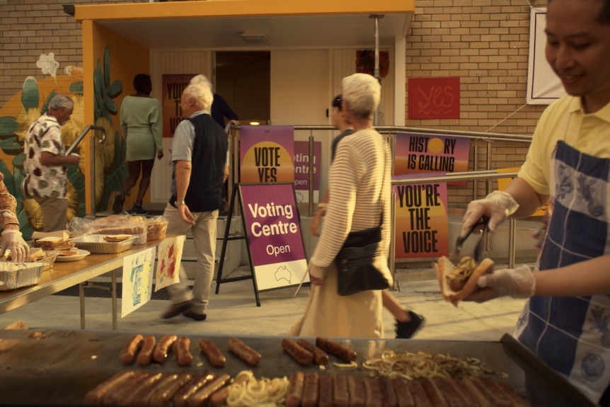 Sausage sizzle outside polling booth, signs say You're The Voice