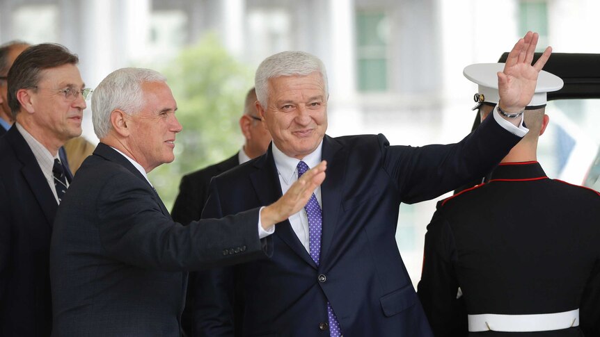 US Vice President Mike Pence and Montenegro Prime Minister Dusko Markovic wave to members of the media.