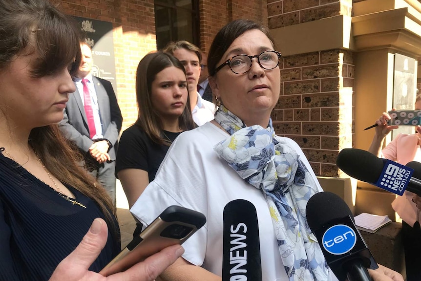 Kimberley McGurk, wife of murdered Sydney man Michael McGurk, surrounded by media and family outside Supreme Court in Sydney.