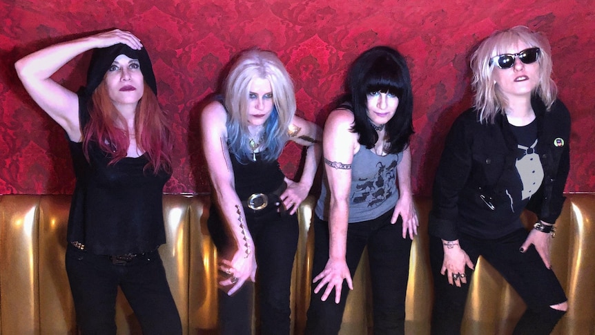 Four women from rock band L7 stand side-by-side