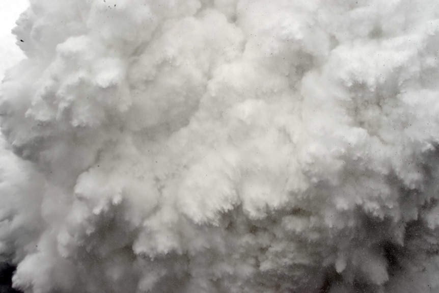 A wall of snow and ice bears down on the base camp.