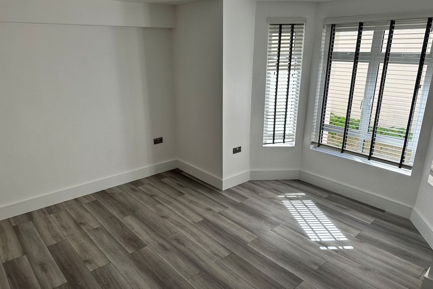 grey floorboards in a living area with large windows