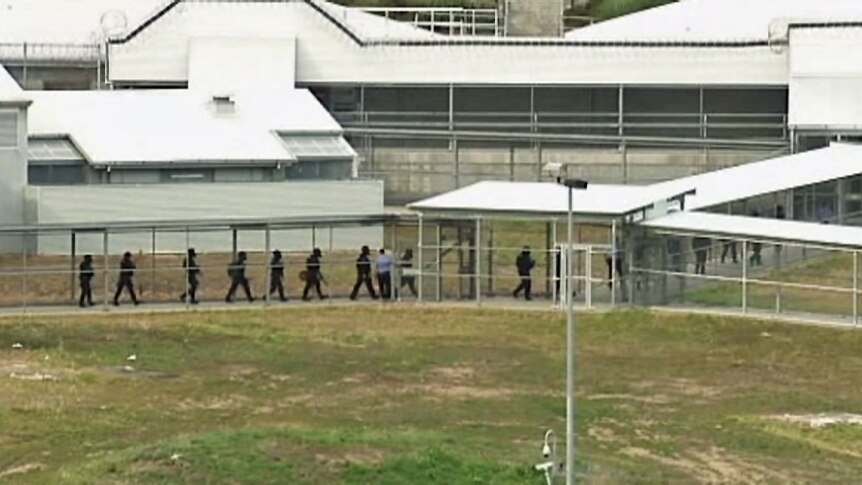 Special Operations Group officers move through Risdon Prison during the hostage situation.