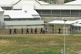 Special Operations Group officers move through Risdon Prison during the hostage situation.