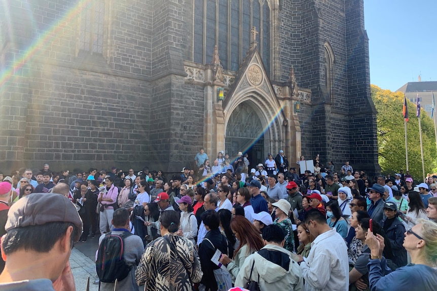 People gather outside of a church.