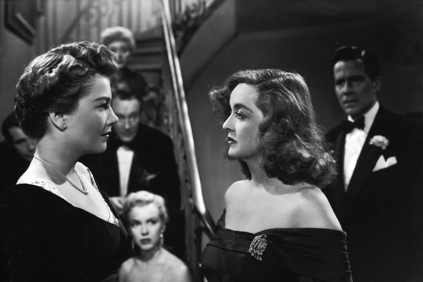 A young woman is confronted by an older woman in an old movie.