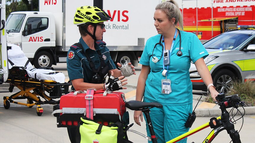 A bicycle paramedic talks to a nurse