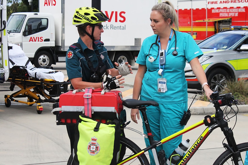 A bicycle paramedic talks to a nurse