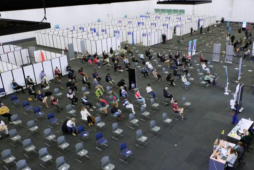 People waiting on seats in a large room