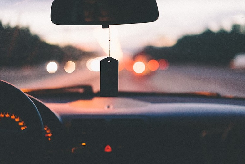 A car dashboard with an air freshener.