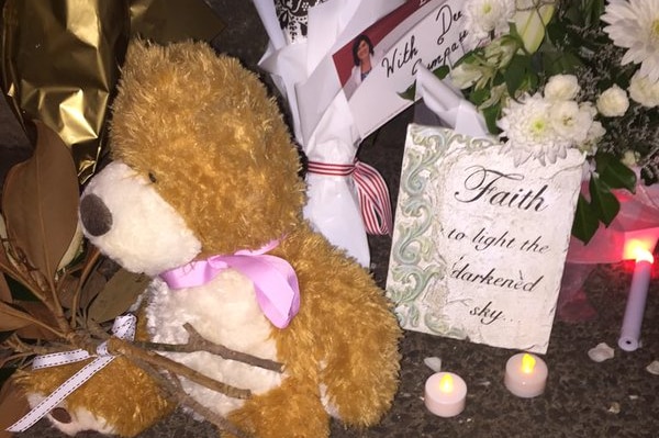 A teddy left at a candlelight vigil for Queenie Xu.