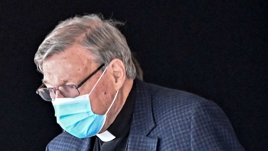 Australian Cardinal George Pell prepares to get into a car after landing at Rome's Fiumicino airport.