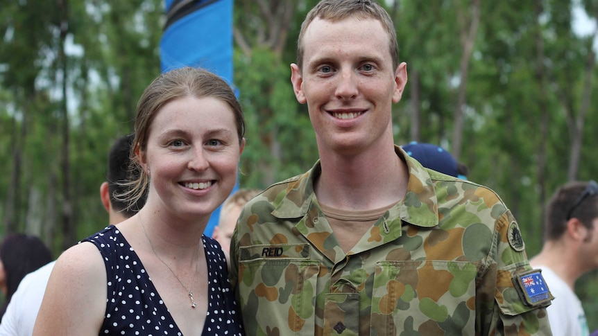 A man in military uniform and a woman at an event.