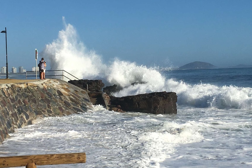 A wave explodes on a sea wall at Mooloolaba