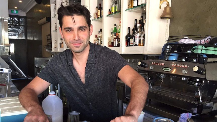 A man serves a coffee in a bar.