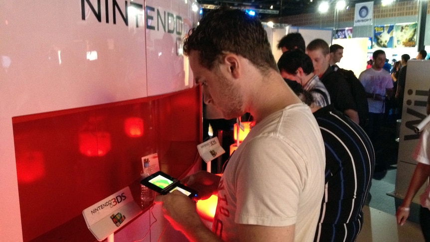 A gamer plays the Nintendo 3DS at the EB Expo