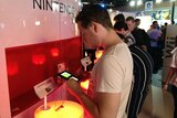 A gamer plays the Nintendo 3DS at the EB Expo