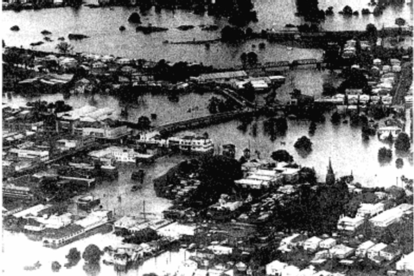 A black and white photo of a town inundated with flood water