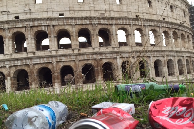 Trash litters the grass outside the colosseum in Rome