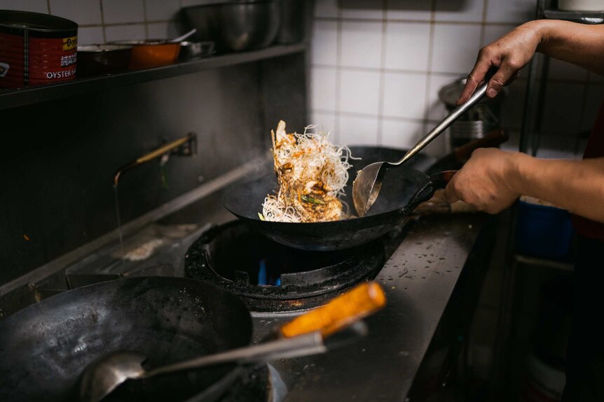 Noodles being tossed at a kitchen at Spencer Village