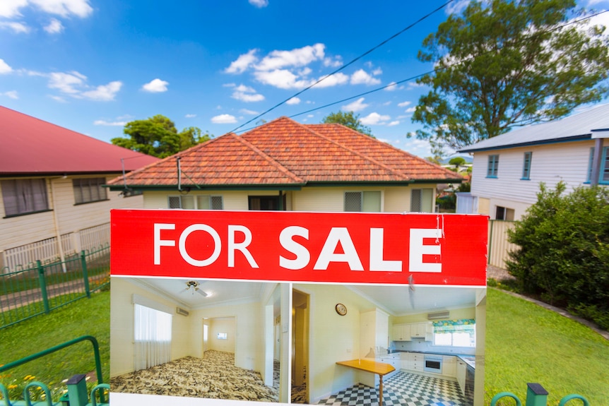 a house for sale in the brisbane suburb of stafford with the sale sign in the front yard 