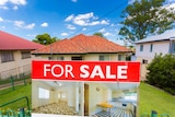 a house for sale in the brisbane suburb of stafford with the sale sign in the front yard 