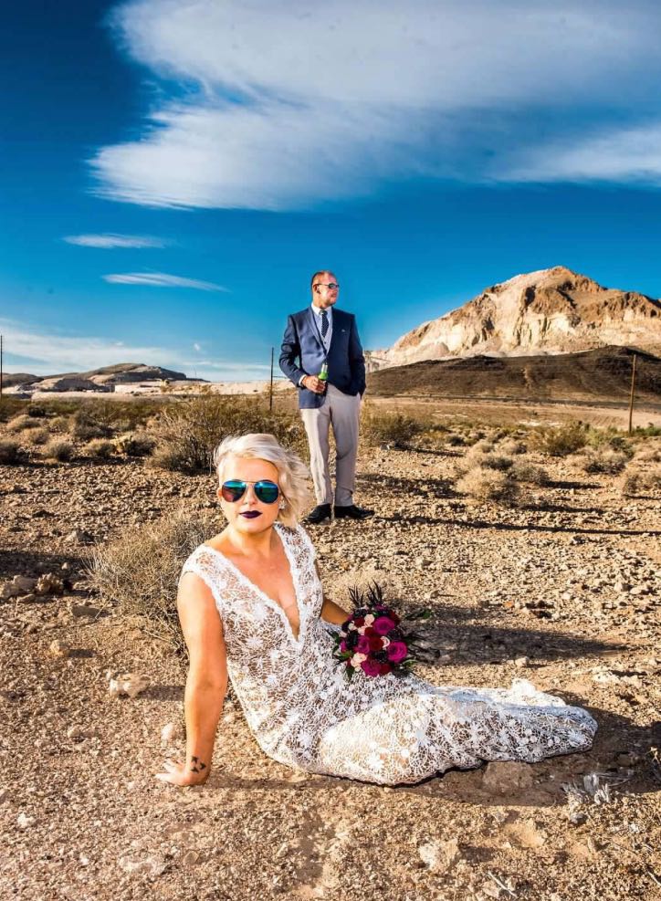 A portrait of a woman on the dessert ground in vegas wearing a wedding dress