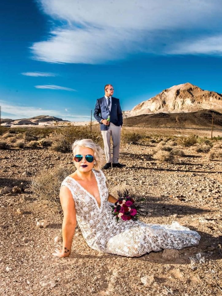 A portrait of a woman on the dessert ground in vegas wearing a wedding dress