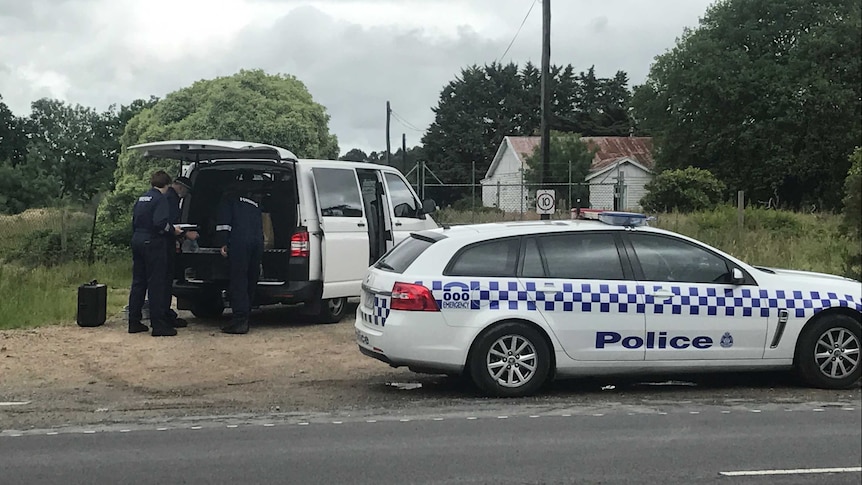 Victoria Police officers and vehicles at a Tyabb property where a body was found.