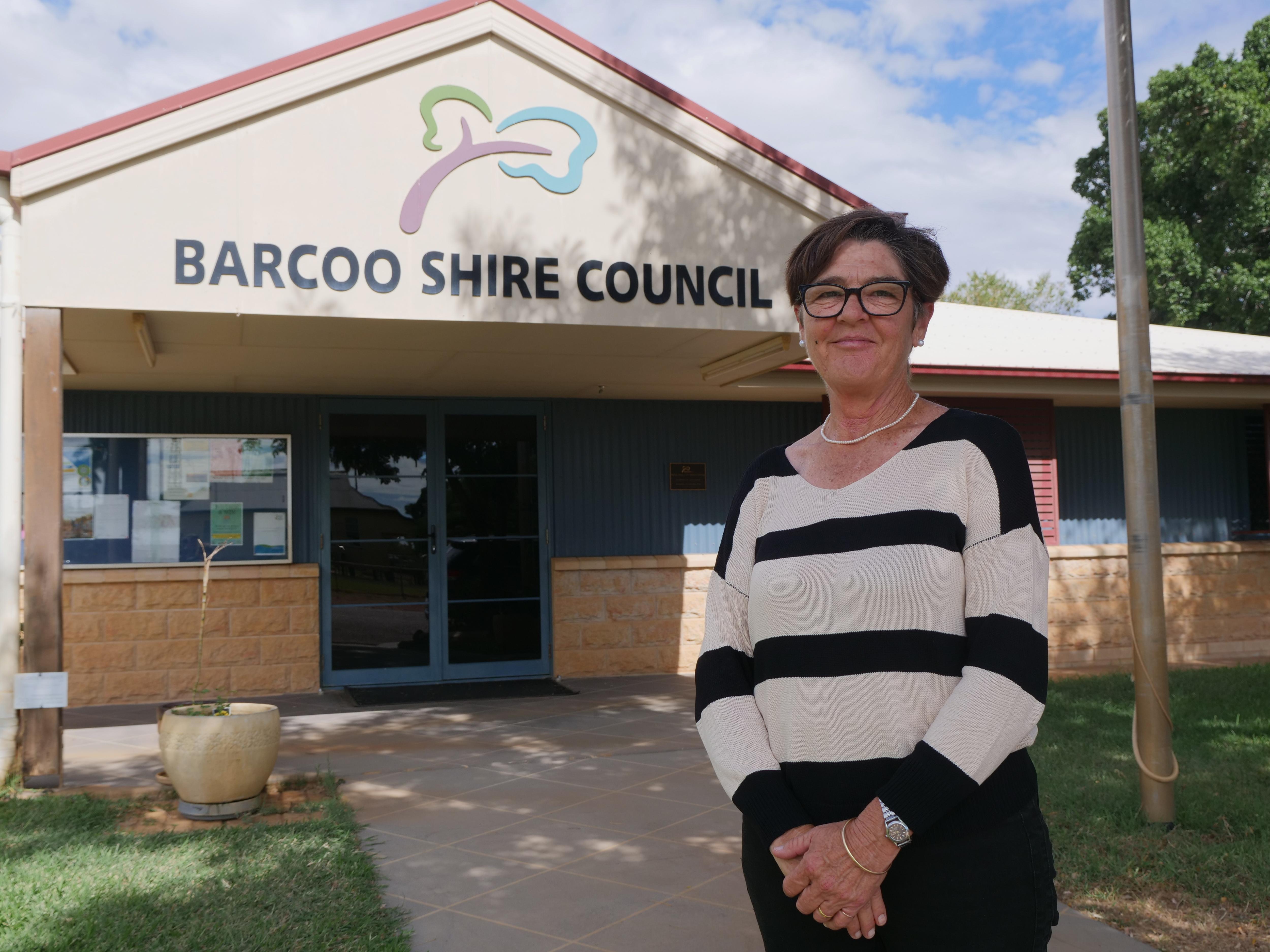 Woman in black and white shirt stands out the front of a council building.
