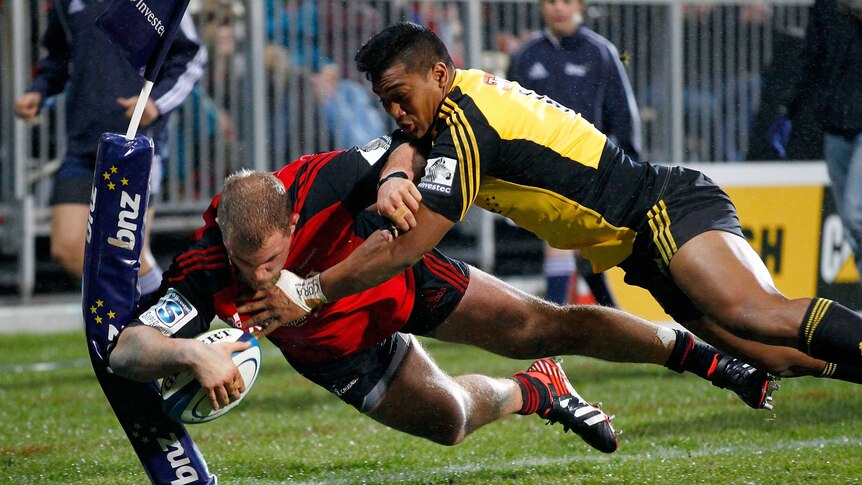 The Crusaders' Owen Franks is tackled by Julian Savea of the Hurricanes in Christchurch.