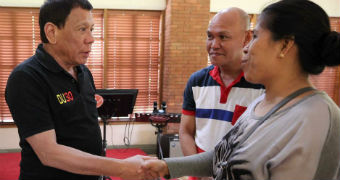 Duterte shakes hands with parents of Kian delos Santos