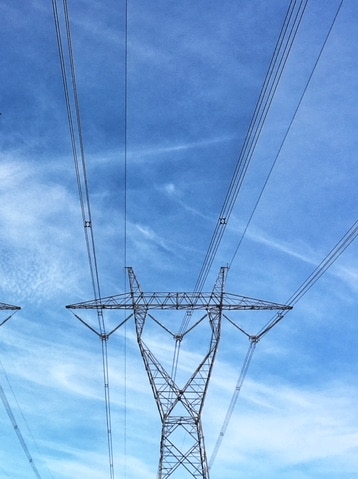 Powerlines in Gippsland in Victoria on a blue sky day.