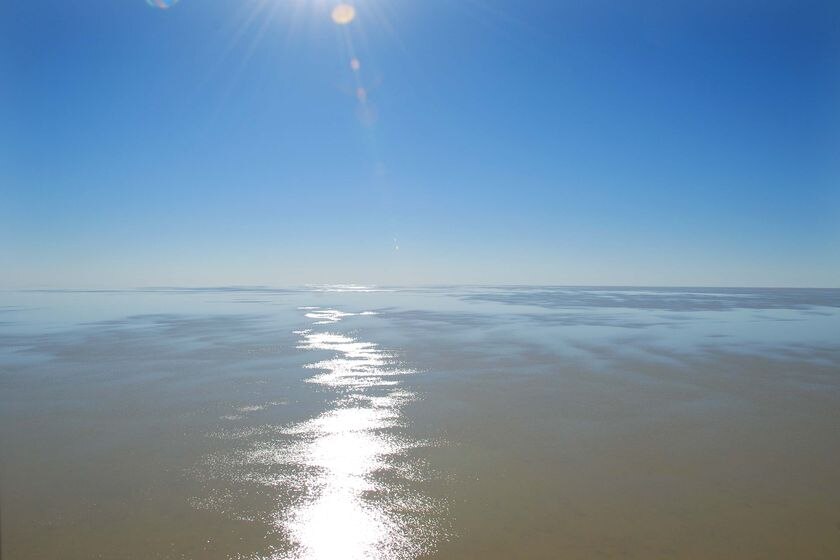 The sun reflects off the surface of Lake Eyre