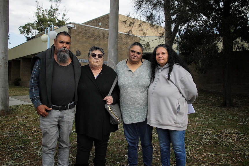 A distressed family standing outside court